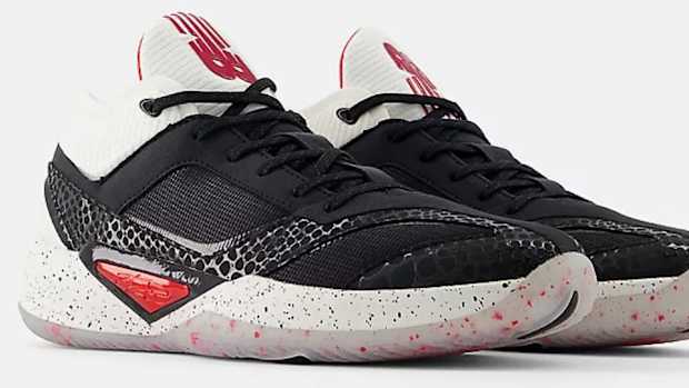 Side view of black and white New Balance shoes.